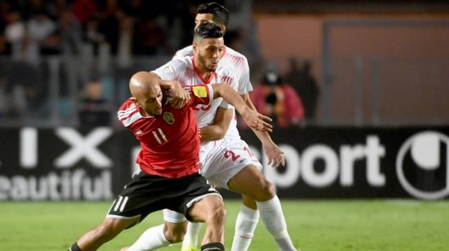 Anice Badri vying for the ball in a Tunisia - Libya game. (AFP Photo)